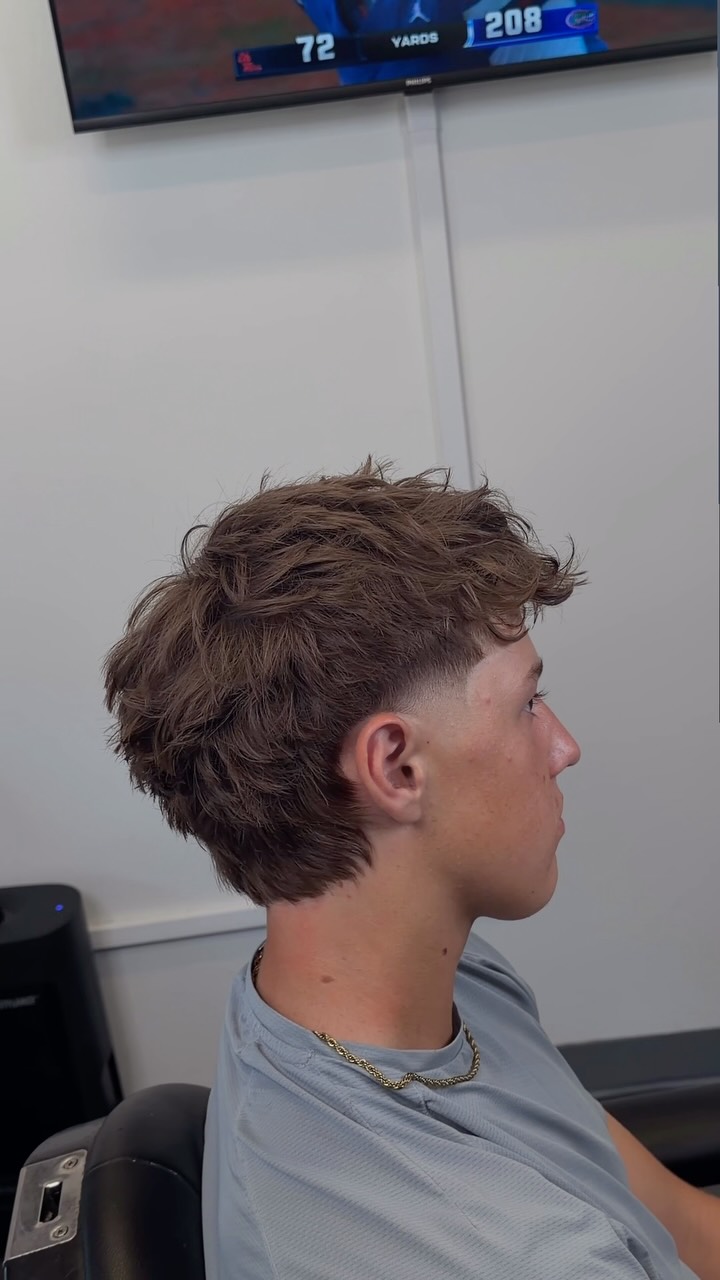 Chris’s recent textured mullet with soft layers and a tapered finish